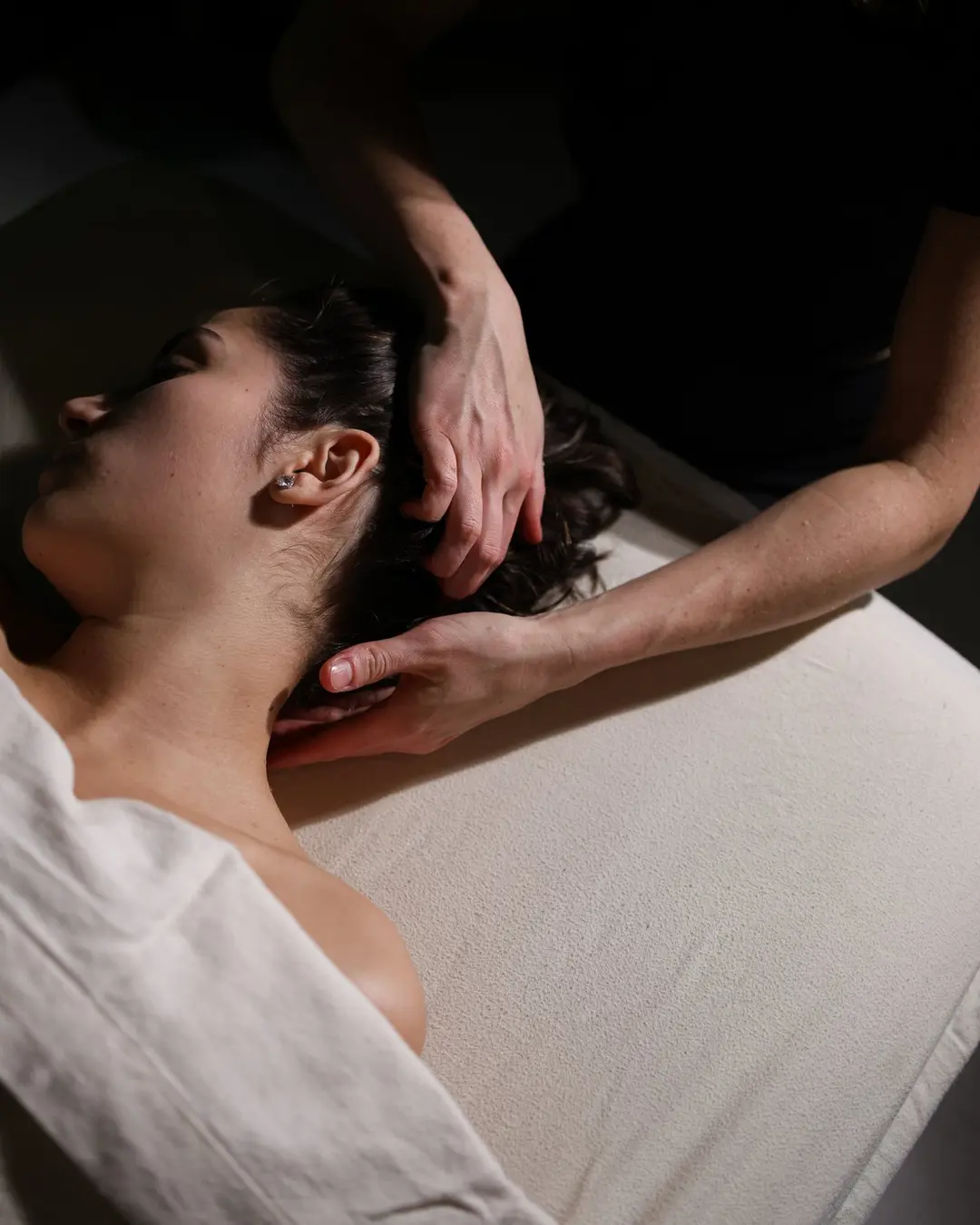 Massage therapist providing attentive bodywork to a client at The Quiet Room