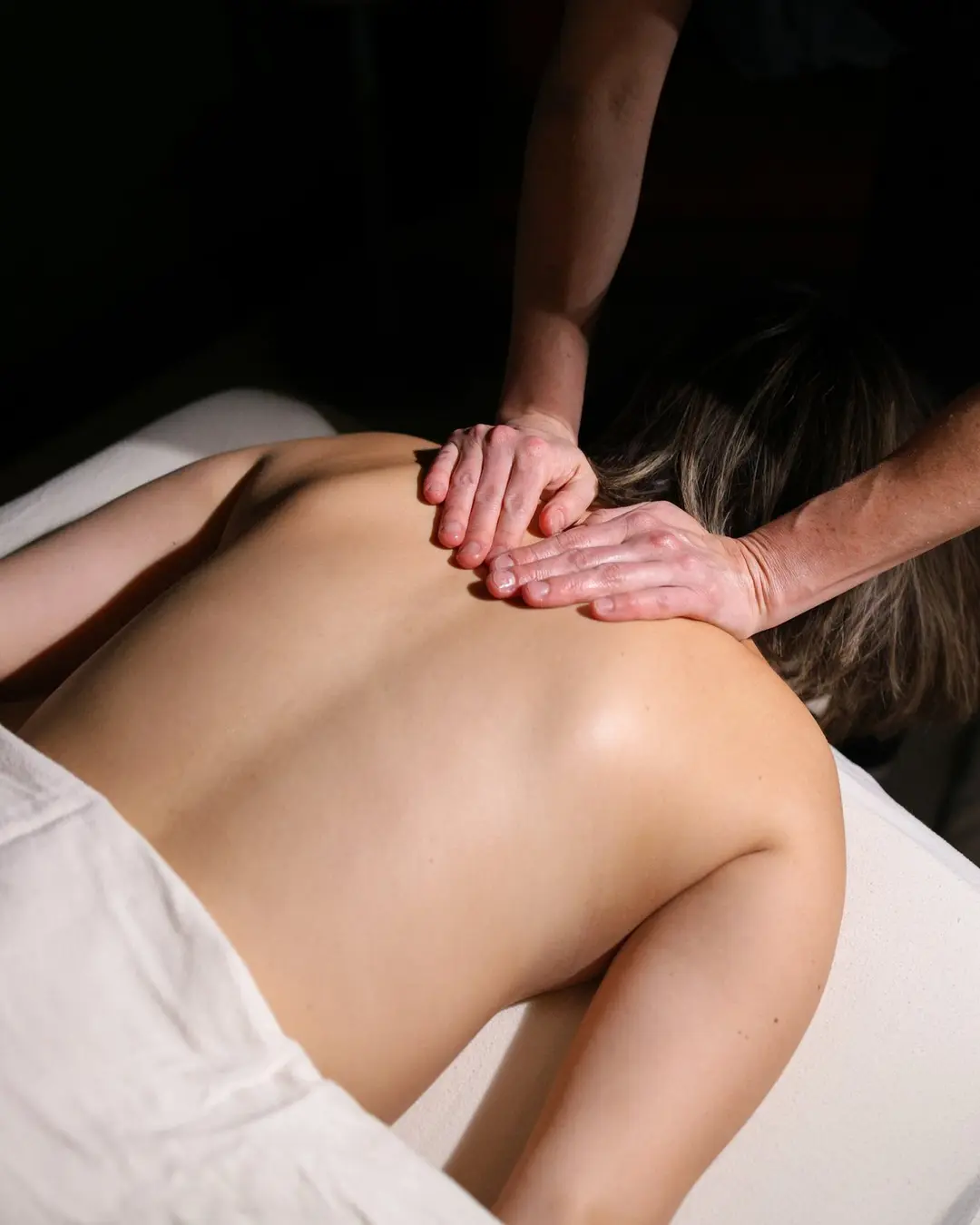 Massage therapist providing attentive bodywork to a client at The Quiet Room